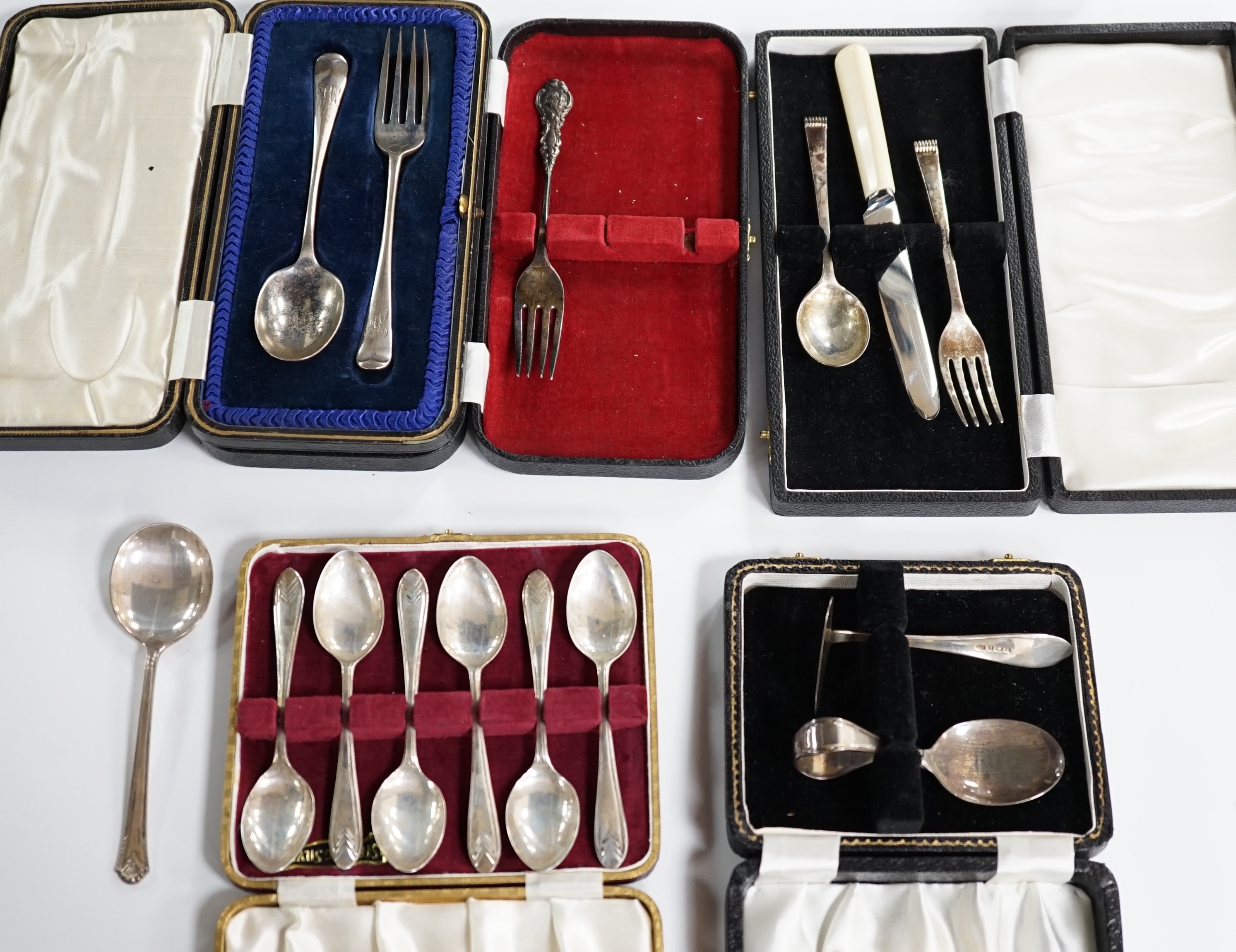 A cased set of six mid 20th century silver teaspoons, a cased silver spoon and pusher, two cased silver christening sets, a boxed silver spoon and one other incomplete cased set. Condition - poor to fair